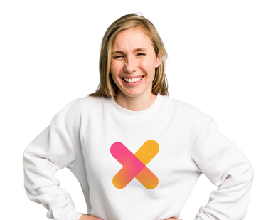 Happy woman with white jumper and coloured cross on the front with hands on hips